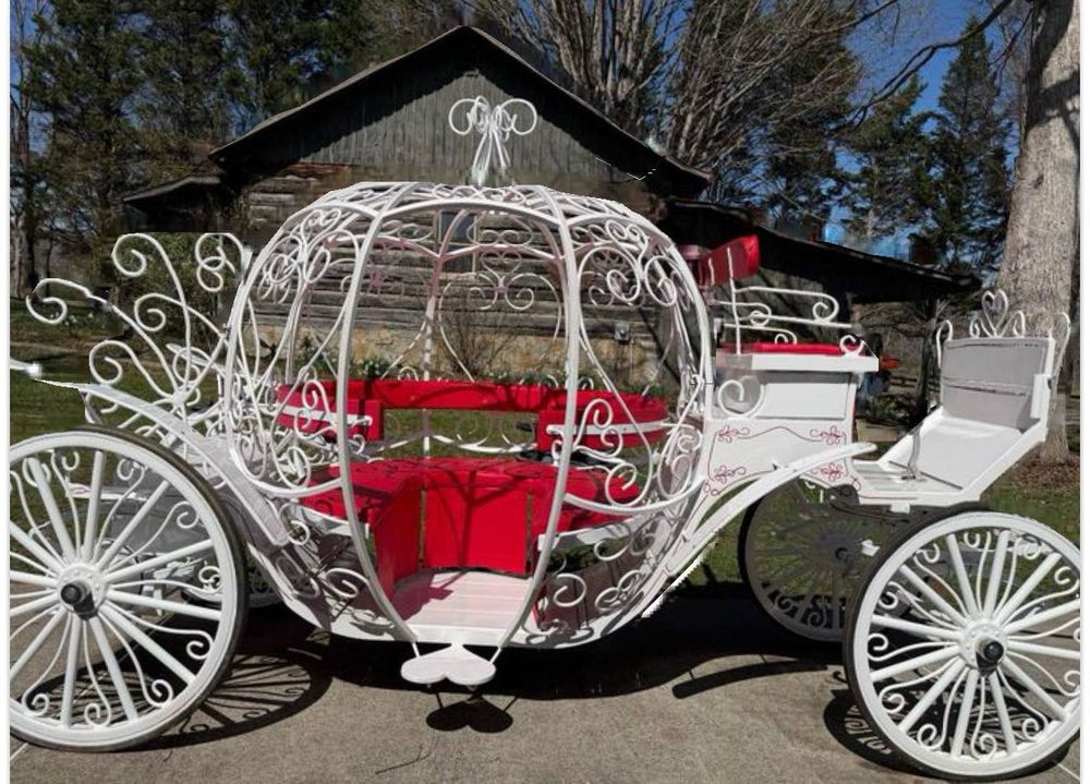 A white Cinderella-style pumpkin carriage with red velvet seats